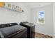 Bright laundry room features modern washer/dryer, wire shelving and a window for natural light at 6476 W Mulberry Way, Greenfield, IN 46140