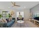 Stylish living room features modern decor, sliding glass doors, and a ceiling fan at 6476 W Mulberry Way, Greenfield, IN 46140