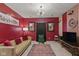 Stylish living room with a tan couch, an accent rug, and bold red walls with modern decor at 6476 W Mulberry Way, Greenfield, IN 46140