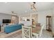 Open concept living space features a dining area, kitchen, and stylish blue sofas at 6476 W Mulberry Way, Greenfield, IN 46140