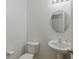 Clean powder room features a pedestal sink, modern fixtures, and a neutral color palette at 6476 W Mulberry Way, Greenfield, IN 46140