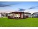 Lovely backyard featuring a deck with pergola, ample seating, and well-maintained grass, perfect for outdoor enjoyment at 676 Nelson Dr, Mooresville, IN 46158