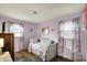 Charming bedroom featuring hardwood floors and unicorn-themed accents at 676 Nelson Dr, Mooresville, IN 46158