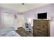 Bedroom featuring hardwood floors, closet, TV, and easy bath access at 676 Nelson Dr, Mooresville, IN 46158
