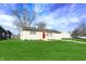 Single-story home with well-kept lawn, attached garage, and tidy landscaping under a bright sky at 676 Nelson Dr, Mooresville, IN 46158