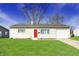 Charming single-story home with a well-maintained lawn and a bright red front door at 676 Nelson Dr, Mooresville, IN 46158