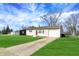 Inviting single-story home with a well-manicured lawn and driveway leading to an attached garage at 676 Nelson Dr, Mooresville, IN 46158