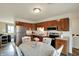 Eat-in kitchen featuring wood cabinets, modern appliances, and a cozy dining area at 676 Nelson Dr, Mooresville, IN 46158
