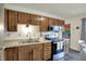 Charming kitchen features wood cabinets and modern stainless-steel appliances at 676 Nelson Dr, Mooresville, IN 46158