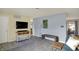 Open living room area with a modern TV setup, stylish seating, and sleek flooring at 676 Nelson Dr, Mooresville, IN 46158