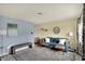 Bright living room with a comfy blue sofa, plush rug, and neutral walls at 676 Nelson Dr, Mooresville, IN 46158