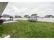 Spacious backyard featuring a trampoline, gazebo with outdoor furniture, and a full privacy fence at 694 N Sobota Way, Trafalgar, IN 46181