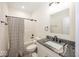 Bathroom with granite countertop, shower-tub combo and black hardware at 694 N Sobota Way, Trafalgar, IN 46181