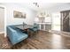 Dining area with blue upholstered seating and a built-in dog crate at 694 N Sobota Way, Trafalgar, IN 46181