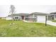 Charming home featuring grey siding, stone accents, a red front door, and a well-manicured lawn at 694 N Sobota Way, Trafalgar, IN 46181
