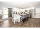 Bright kitchen featuring white cabinetry, granite countertops, stainless steel appliances, and a kitchen island at 694 N Sobota Way, Trafalgar, IN 46181