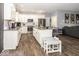 Bright kitchen with white cabinets, stainless steel appliances, granite countertops, and an island at 694 N Sobota Way, Trafalgar, IN 46181