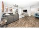 Cozy living room with hardwood floors, a gray sectional sofa, and a mounted TV at 694 N Sobota Way, Trafalgar, IN 46181