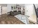 Inviting living room with hardwood floors, a sectional sofa, a cat tree, and a modern area rug at 694 N Sobota Way, Trafalgar, IN 46181