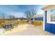 Lovely wooden back deck featuring an outdoor seating area and gate access to the expansive backyard at 7212 E Rocklane Rd, Needham, IN 46162