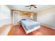 Bedroom with hardwood floors, wood wall, a window and ceiling fan at 7212 E Rocklane Rd, Needham, IN 46162