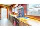 Rustic kitchen featuring butcher block countertops, stainless steel hood, and ample natural light from the window at 7212 E Rocklane Rd, Needham, IN 46162
