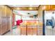 Kitchen with view to Living Room featuring butcher block island and stainless steel refrigerator at 7212 E Rocklane Rd, Needham, IN 46162
