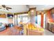 Open-concept floor plan showcasing hardwood floors, wood beams, and a bar with seating at 7212 E Rocklane Rd, Needham, IN 46162