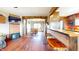 Inviting living space showcases hardwood floors, wood beams, and an open layout to the dining room at 7212 E Rocklane Rd, Needham, IN 46162