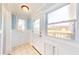 Cozy mudroom offers tiled floors, windows, and a back door entrance to the property at 7212 E Rocklane Rd, Needham, IN 46162
