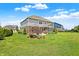 Spacious backyard featuring a patio, screened-in porch, and well-manicured lawn at 7251 Birch Leaf Dr, Indianapolis, IN 46259