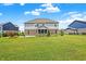 Large backyard showing a house with a screened-in porch, patio, and grassy lawn at 7251 Birch Leaf Dr, Indianapolis, IN 46259