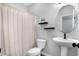 Clean bathroom with a pedestal sink, modern mirror, and a shower featuring a beige curtain at 7251 Birch Leaf Dr, Indianapolis, IN 46259