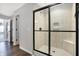 Modern bathroom featuring a tiled shower with glass doors and a built-in seat at 7251 Birch Leaf Dr, Indianapolis, IN 46259