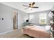 Bedroom showcasing natural light with neutral walls, an open closet, carpeted floors, and a ceiling fan at 7251 Birch Leaf Dr, Indianapolis, IN 46259