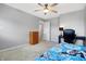 Bedroom with carpeted floors, a ceiling fan, a desk, a closet, and large windows to allow natural light at 7251 Birch Leaf Dr, Indianapolis, IN 46259