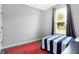 Bright and airy bedroom with neutral walls and a cozy blue-striped bed next to the window at 7251 Birch Leaf Dr, Indianapolis, IN 46259