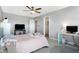 Bedroom featuring a ceiling fan, an open closet, carpeted floors, and large windows for natural lighting at 7251 Birch Leaf Dr, Indianapolis, IN 46259