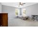 Bedroom with gray carpet, neutral walls, a ceiling fan, and natural lighting from the two large windows at 7251 Birch Leaf Dr, Indianapolis, IN 46259