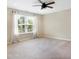 Spacious bedroom with a ceiling fan, a large window with curtains, and neutral carpet at 7251 Birch Leaf Dr, Indianapolis, IN 46259