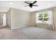 Spacious bedroom with a ceiling fan, a large window with curtains, and neutral carpet at 7251 Birch Leaf Dr, Indianapolis, IN 46259