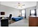 Bedroom featuring carpeted floors, natural lighting, a ceiling fan, a desk, and a comfortable chair at 7251 Birch Leaf Dr, Indianapolis, IN 46259