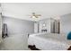 Large main bedroom with ceiling fan, neutral carpet, and entry door to the bathroom at 7251 Birch Leaf Dr, Indianapolis, IN 46259
