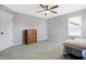 Bedroom features neutral paint, carpet, ceiling fan, window with blinds, and white door at 7251 Birch Leaf Dr, Indianapolis, IN 46259
