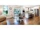 Eat-in kitchen featuring white cabinets, stainless steel appliances, and a cozy dining area at 7251 Birch Leaf Dr, Indianapolis, IN 46259