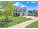 Attractive two-story home showcasing a well-kept lawn, concrete driveway and established landscaping at 7251 Birch Leaf Dr, Indianapolis, IN 46259