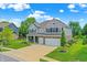 Charming two-story home with well-manicured lawn, three-car garage, and inviting curb appeal at 7251 Birch Leaf Dr, Indianapolis, IN 46259