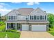 Beautiful two-story home with gray siding, brick accents, and a well-manicured lawn at 7251 Birch Leaf Dr, Indianapolis, IN 46259