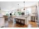 Open-concept kitchen with stainless steel appliances, kitchen island, dining area, and access to the living room at 7251 Birch Leaf Dr, Indianapolis, IN 46259