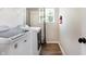 A laundry room featuring white washer and dryer, wire rack shelving, and a window at 7251 Birch Leaf Dr, Indianapolis, IN 46259